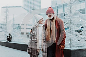 Senior couple walking in winter city center.