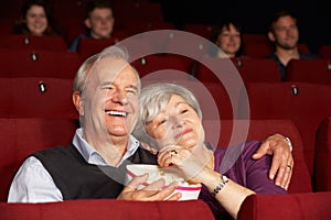 Senior Couple Watching Film In Cinema