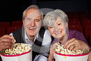 Senior Couple Watching Film In Cinema
