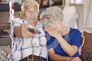 Senior couple watching horror movie