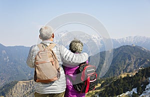 senior couple watching the mountains