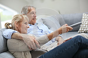 Senior couple watching tv at home