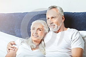 Senior couple wathcing tv at home