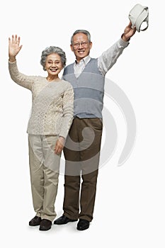 Senior couple waving goodbye
