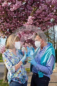 Senior couple wearing surgical face masks