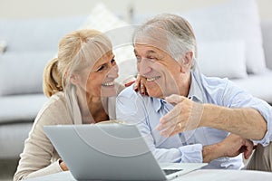 Senior couple websurfing on laptop