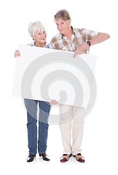 Senior couple with white board