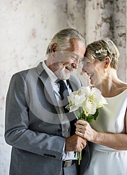 Senior Couple with White Roses Flower Bouquet