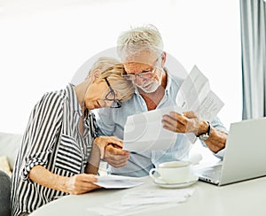 senior couple woman man bill finance tax budget calculator paper document retirement paperwork laptop