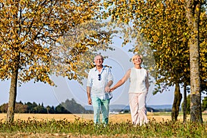 Senior couple, woman and man, having walk