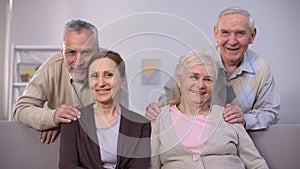 Senior couples hugging and smiling at camera, family portrait, togetherness