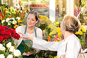 Senior customer buying red roses flower shop