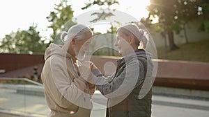 Senior cute couple dating in the park. Husband kissing the woman's hands. Elderly family showing love to each other