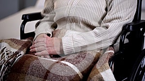 Senior disabled woman covered with blanket closeup, nursing home, retirement