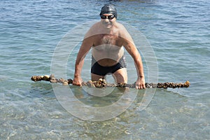 Senior diver with artifact photo