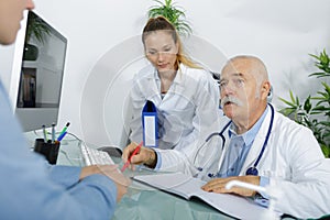 Senior doctor in conversation with patient