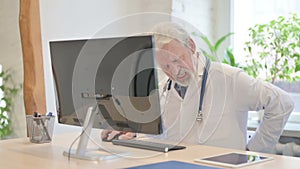 Senior Doctor having Back Pain while Working on Computer