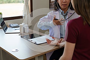 Senior Doctor and her patient. Doctor giving advice to a female patient at hospital