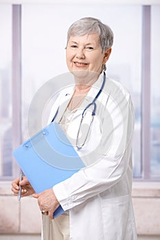 Senior doctor holding notepad