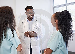 Senior doctor listens to junior healthcare assistant, standing in hospital photo