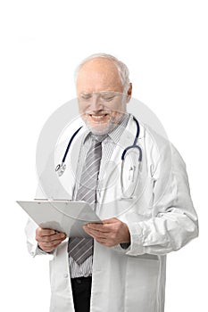 Senior doctor looking at papers smiling