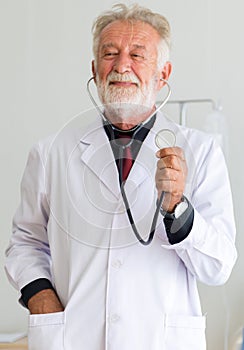 Senior doctor male showing stethoscope for listening heart rate at hospital,Selective focus hands