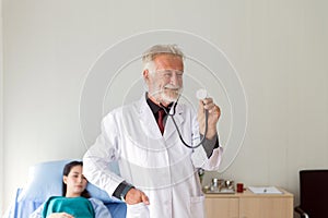 Senior doctor man show stethoscope for listening heart rate at hospital