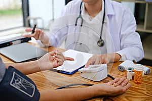 Senior doctor measure blood pressure for asian woman to check her condition