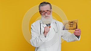 Senior doctor orthodontist man examines a panoramic x-ray picture of the jaw teeth stomatology