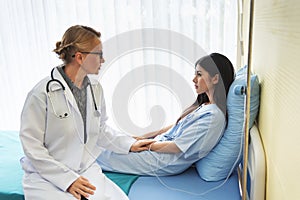 Senior Doctor reassuring Female patient