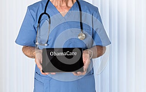 Senior doctor in scrubs facing camera