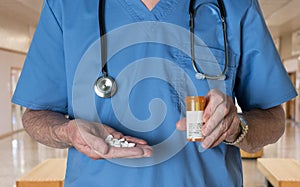 Senior doctor in scrubs with RX tablets