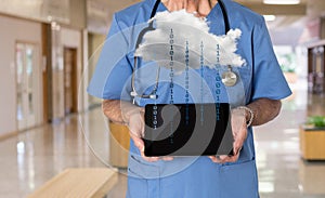 Senior doctor in scrubs with tablet computer