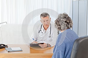 A senior doctor talking with his patient