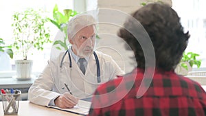 Senior Doctor Talking with Patient for Treatment