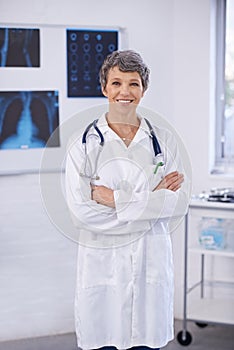 Senior doctor, woman and arms crossed in portrait, radiology for surgery with anatomy scan and healthcare. Medical