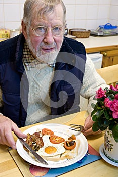 A Senior eating a big breakfast.