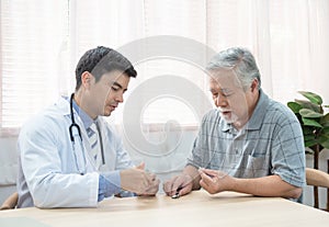 Senior elder asian man asking young caucasian doctor about indications and contraindications of new medicine, healthcare and