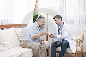 Senior elder asian man asking young caucasian doctor about indications and contraindications of new medicine, healthcare and