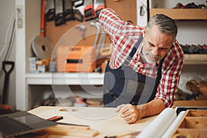 Senior elderly engineer worker back pain muscle cramp from hard working prolonged standing at work