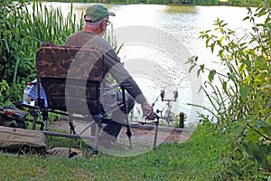 Senior or elderly man fishing or angling.