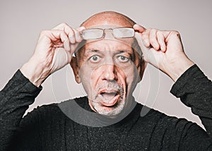 Senior, elderly man in glasses, looking shocked