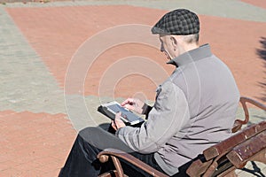 Senior elderly man using tablet computer