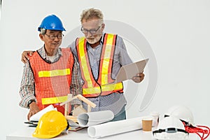 Senior engineer and architect working with drawing