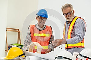 Senior engineer and architect working with drawing