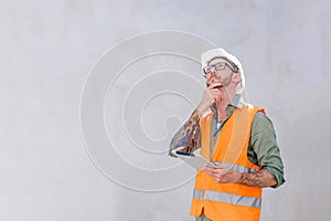 Senior engineer home builder construction worker designer architect standing thinking hand at chin expression with copy space for