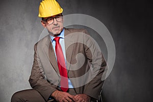 Senior engineer posing seated looking away