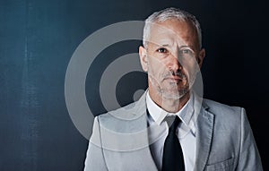 Senior executive, business man and headshot, portrait with confidence and management on dark background. Male CEO