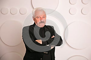 Senior expertise gray hair businessman posing interior white
