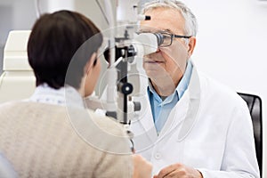 Senior eye specialist look in ophthalmoscope and perform eye rev